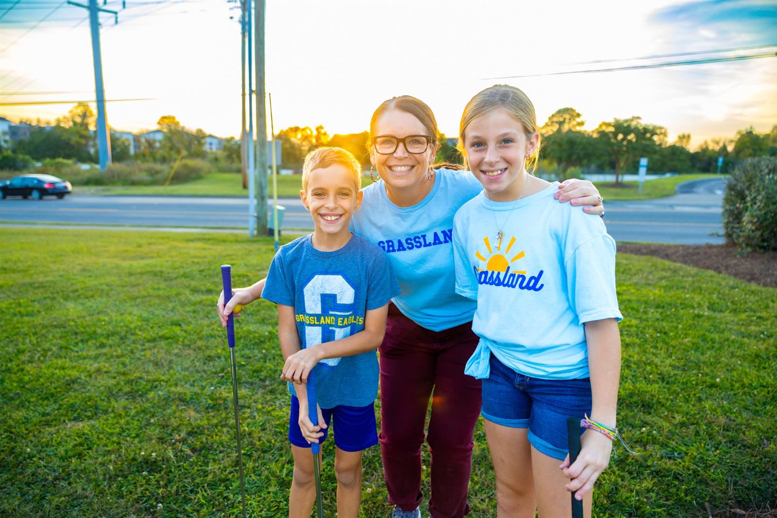 vice principal and two students at mini golf